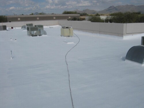 A commercial roof in Scottsdale, AZ that was repaired & recoated with white elastomeric paint from Sunland Coatings.