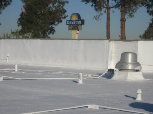 A comerical foof that was repaired and recoated with white elastomeric roof coating by Sunland Coatings.