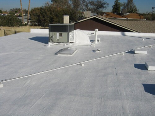 A residential flat roof that was recoated with white elastomeric paint from Sunland Coatings.