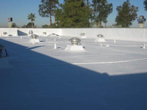 A flat commercial roof coated with Sunland Coatings premium elastomeric paint.